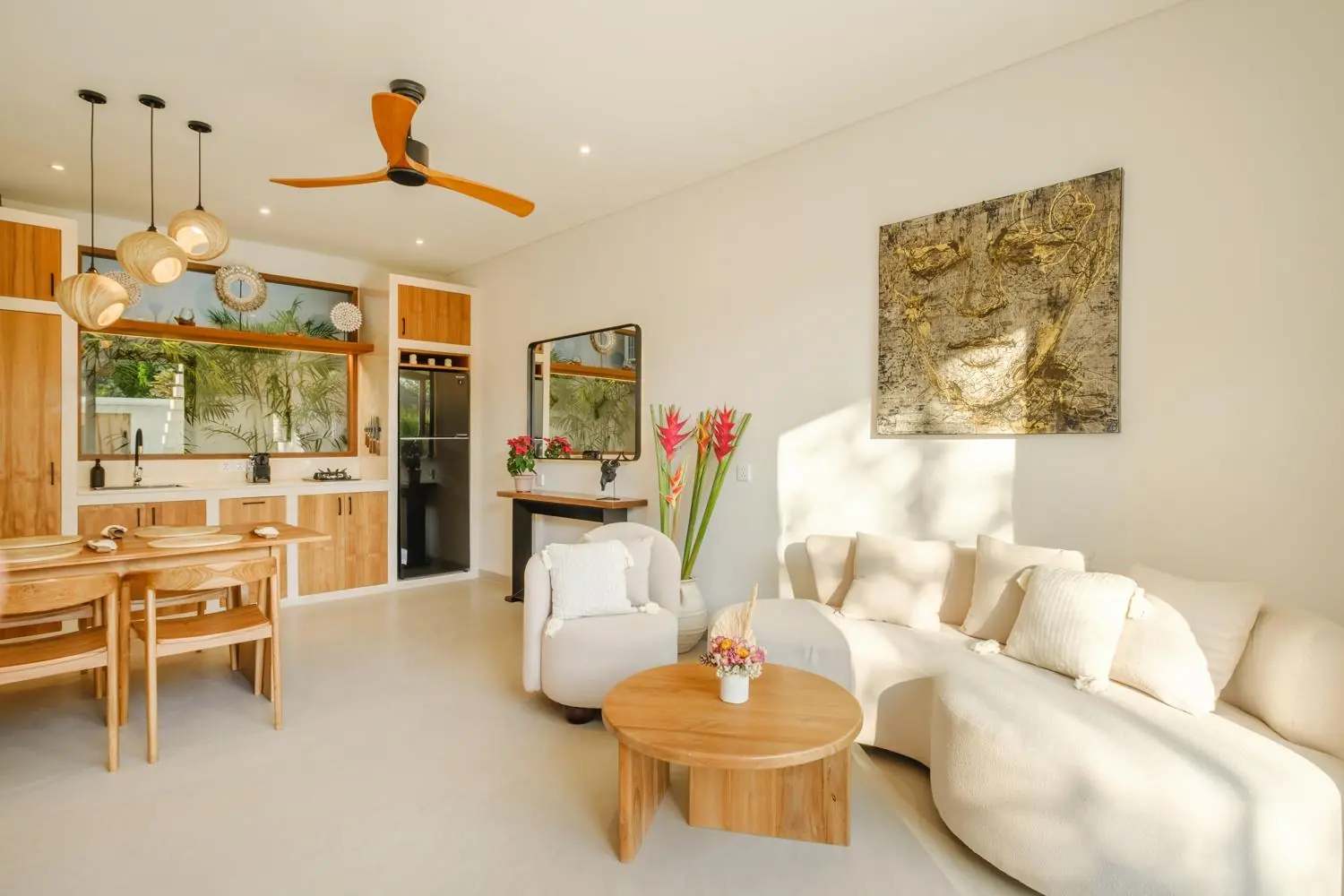 Living room with curved sofa and original artwork Villa Las Hermanas Tumbak Bayu Pererenan Bali
