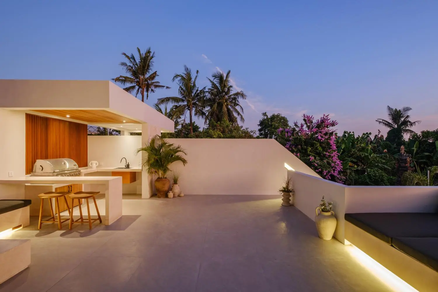 Rooftop terrace with BBQ and palms at dusk Villa Las Hermanas Tumbak Bayu Pererenan Bali