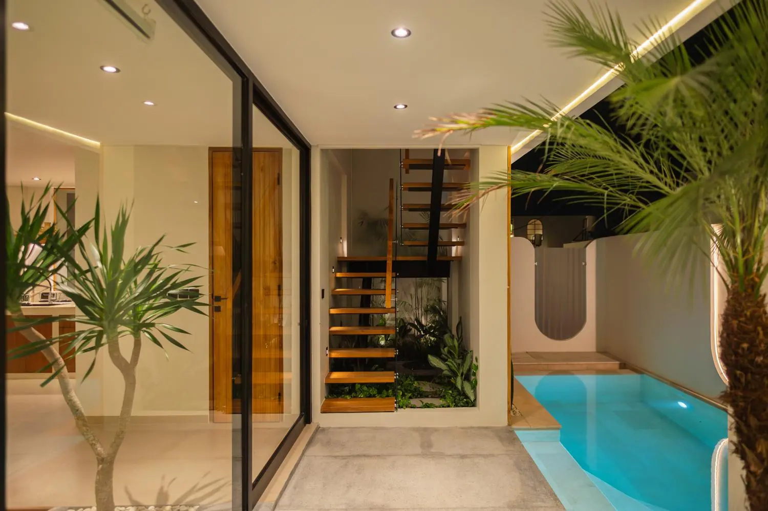 Pool and floating staircase at night Villa Julito Tumbak Bayu Pererenan Bali