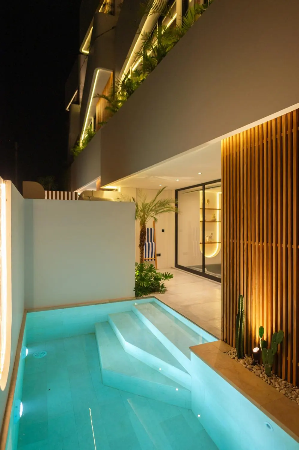 Illuminated pool and facade at night Villa Julito Tumbak Bayu Pererenan Bali