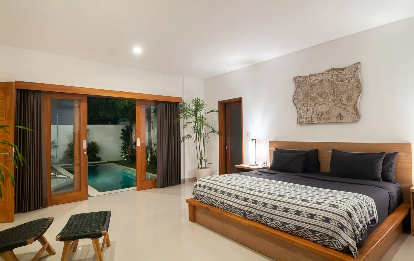 Villa Kesari ground-floor bedroom opening onto the pool Berawa Canggu Bali