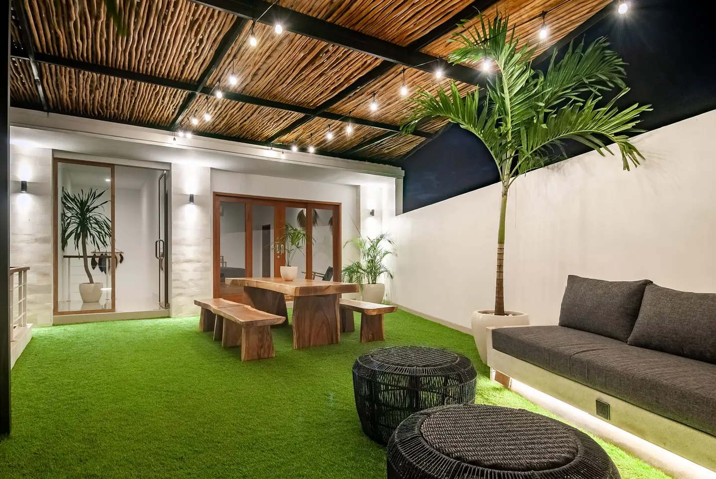 Villa Kesari rooftop sofa lounge and dining table at night Berawa Canggu Bali