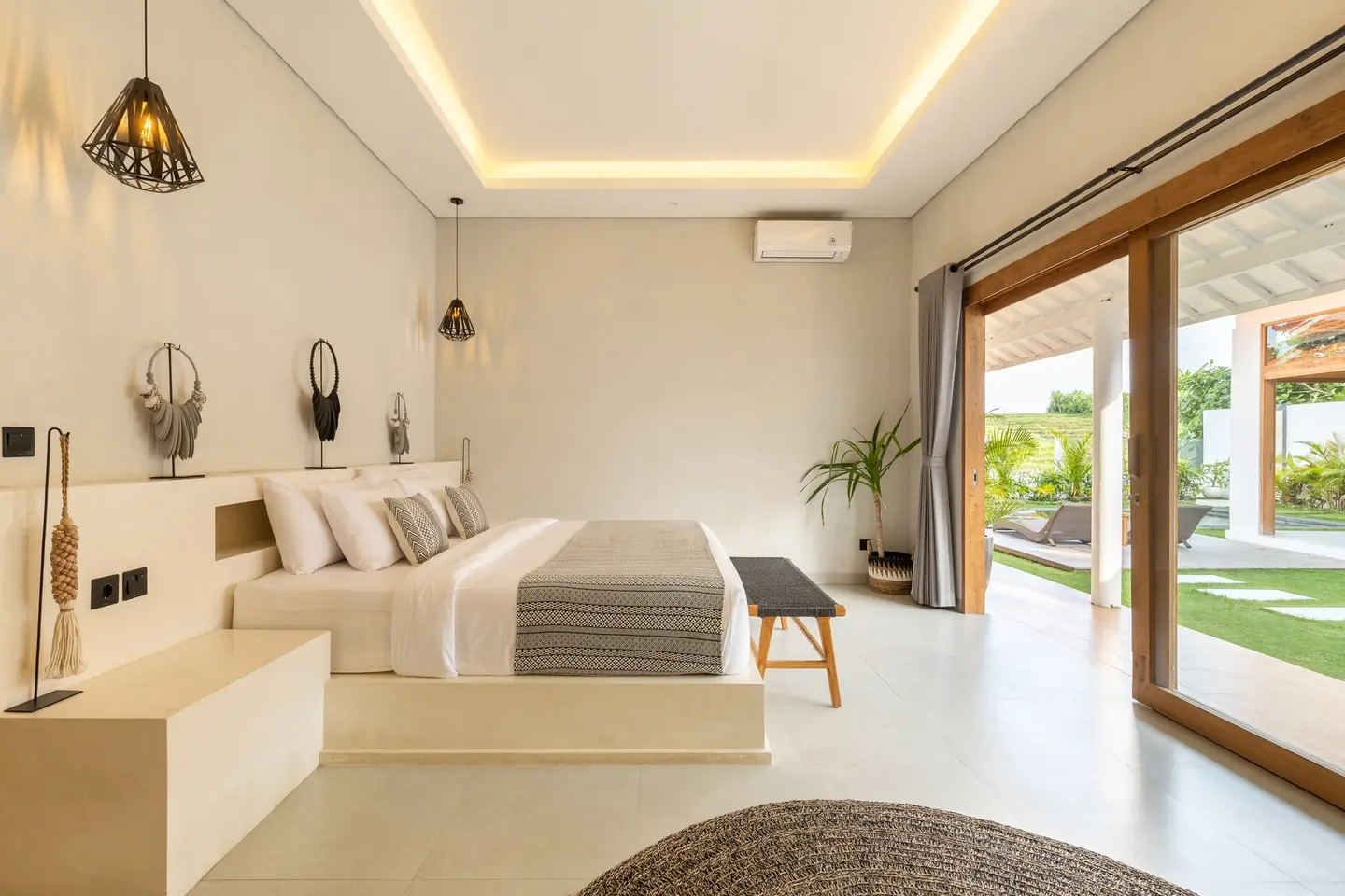 Villa Menaka bedroom opening onto the pool and garden Tumbak Bayu Pererenan Bali