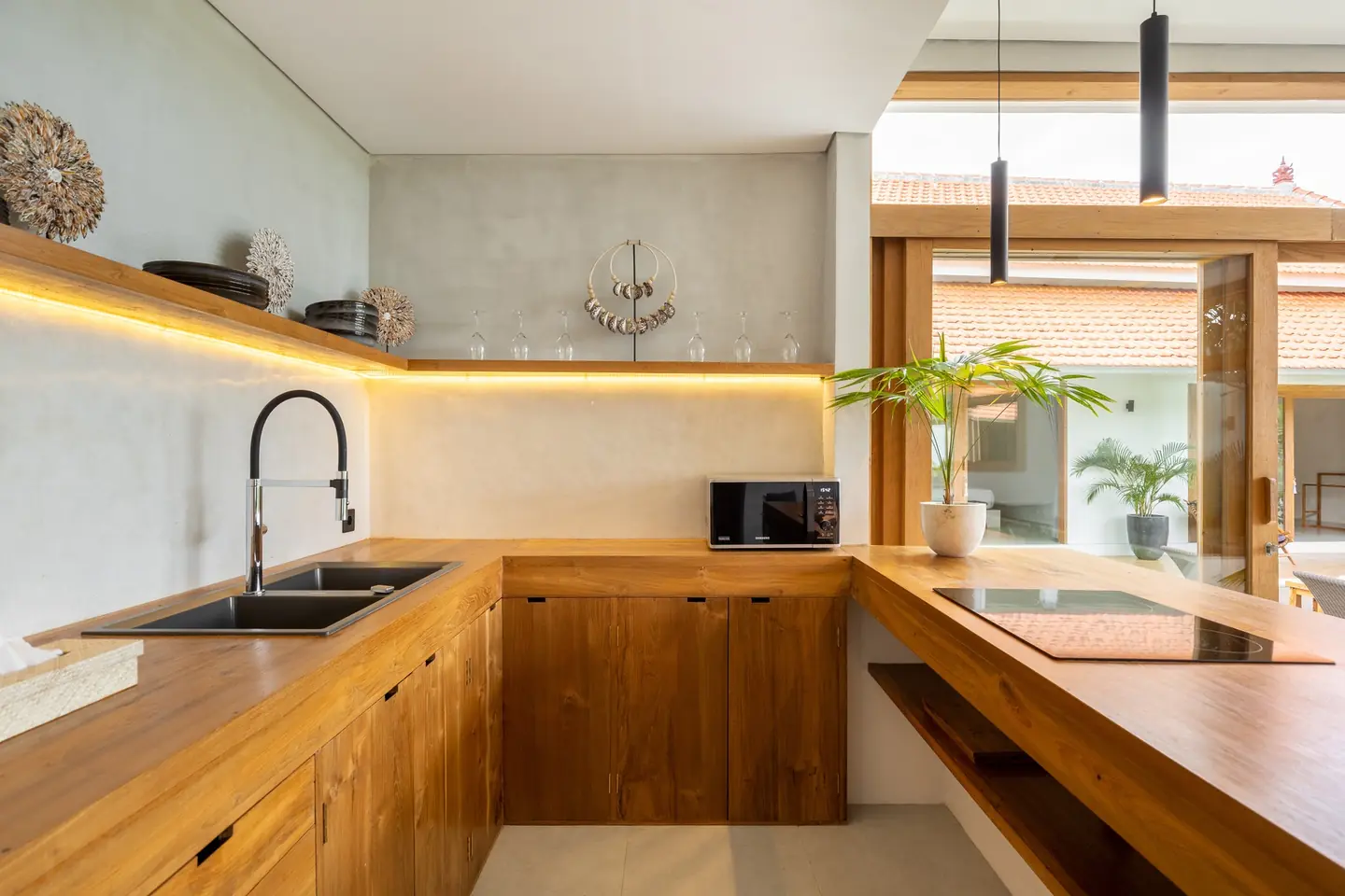 Villa Menaka teak kitchen with garden view Tumbak Bayu Pererenan Bali