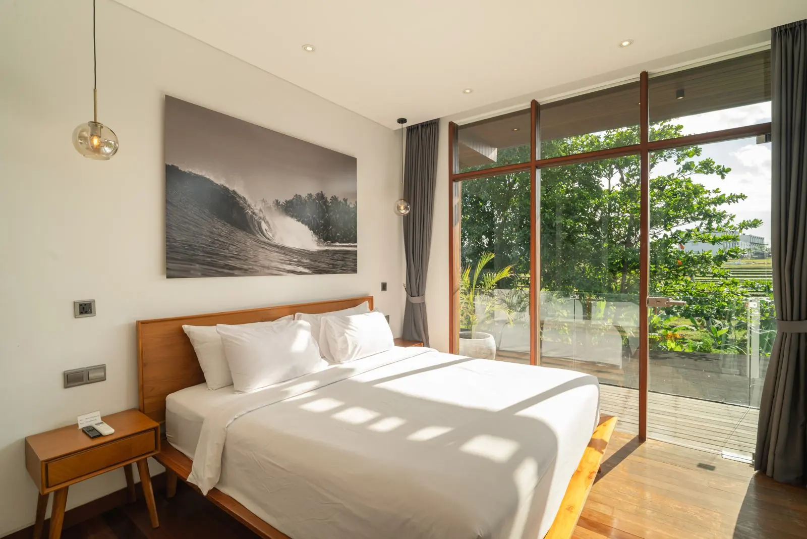 Bedroom with balcony and rice field views River Paradise 5BR Pererenan Bali