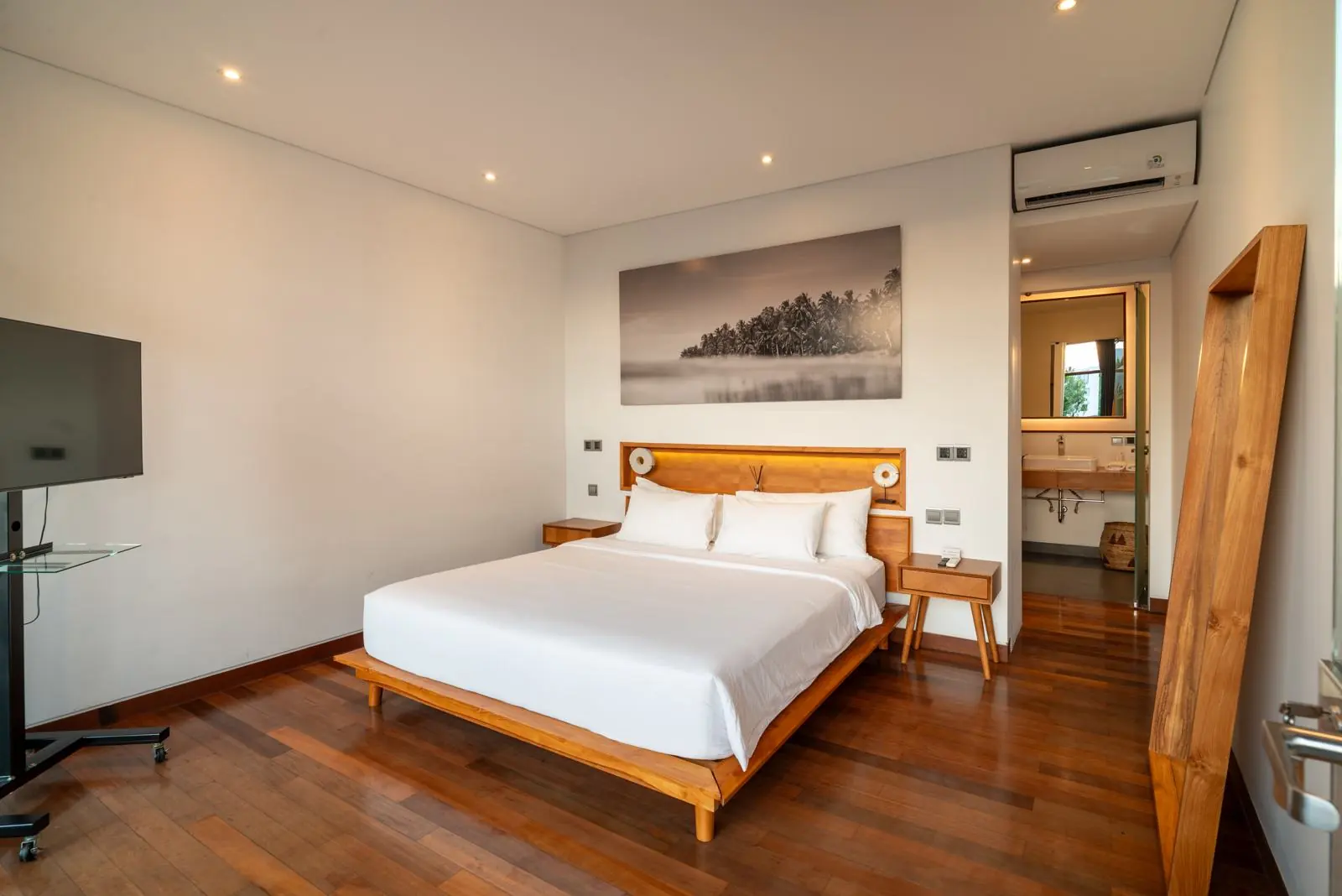 Upper-floor bedroom with timber floors River Paradise 5BR Pererenan Bali
