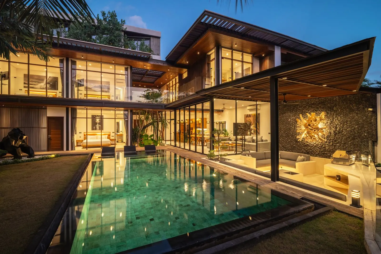 Villa and pool illuminated at dusk River Paradise 5BR Pererenan Bali