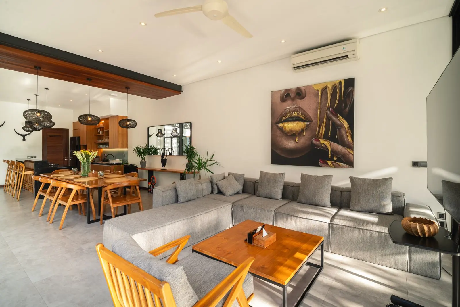 Open living room with original art and garden views River Paradise 5BR Pererenan Bali