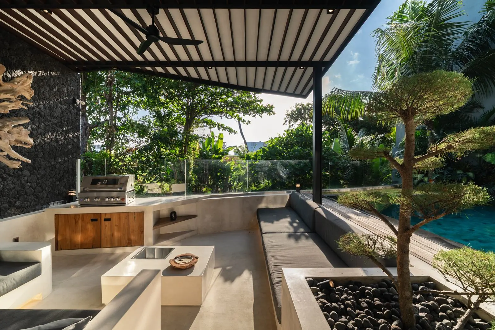 Outdoor lounge with bonsai beside the pool River Paradise 5BR Pererenan Bali