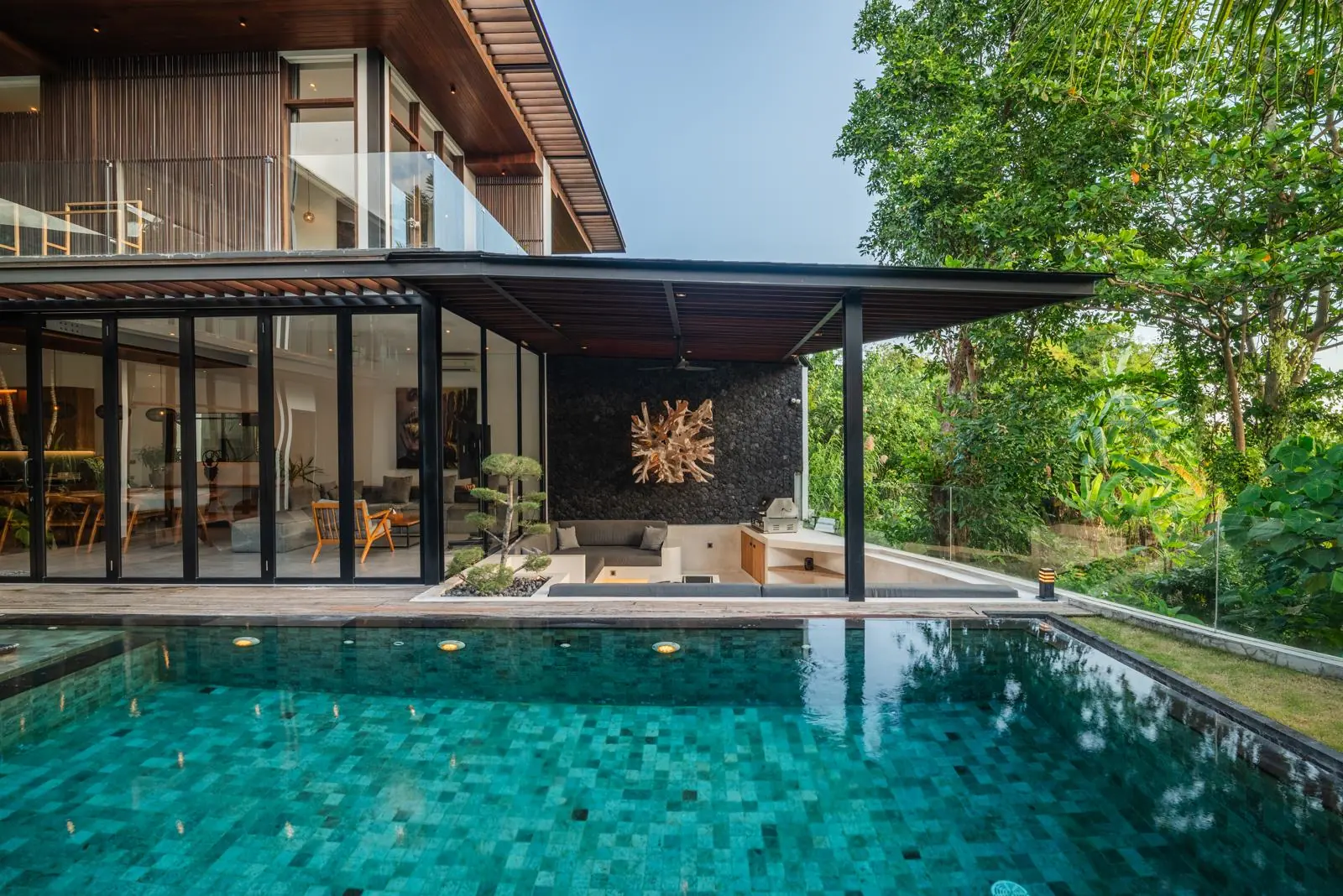 Pool with sunken outdoor lounge and volcanic stone wall River Paradise 5BR Pererenan Bali