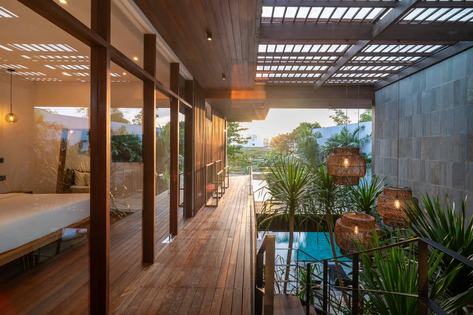 Timber walkway above the pool at sunset River Paradise 5BR Pererenan Bali