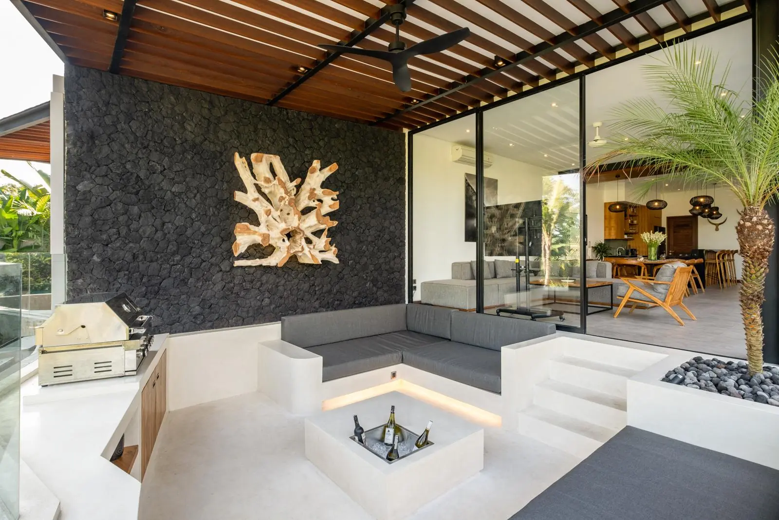 Sunken BBQ lounge with volcanic stone wall River Paradise 4BR Pererenan Bali
