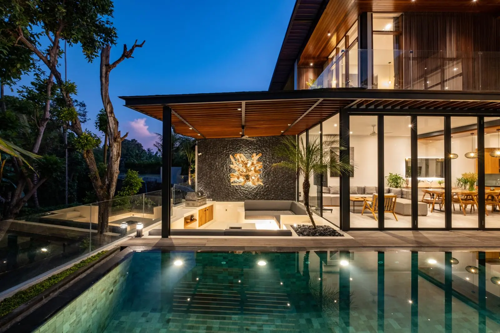 Villa, pool and sunken lounge at dusk River Paradise 4BR Pererenan Bali