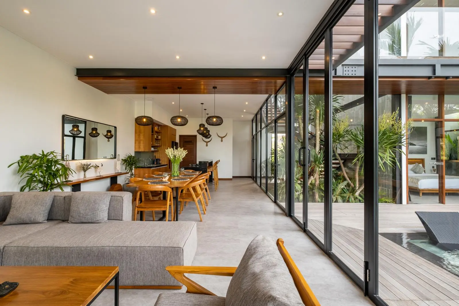 Living and dining room facing the inner tropical garden River Paradise 4BR Pererenan Bali