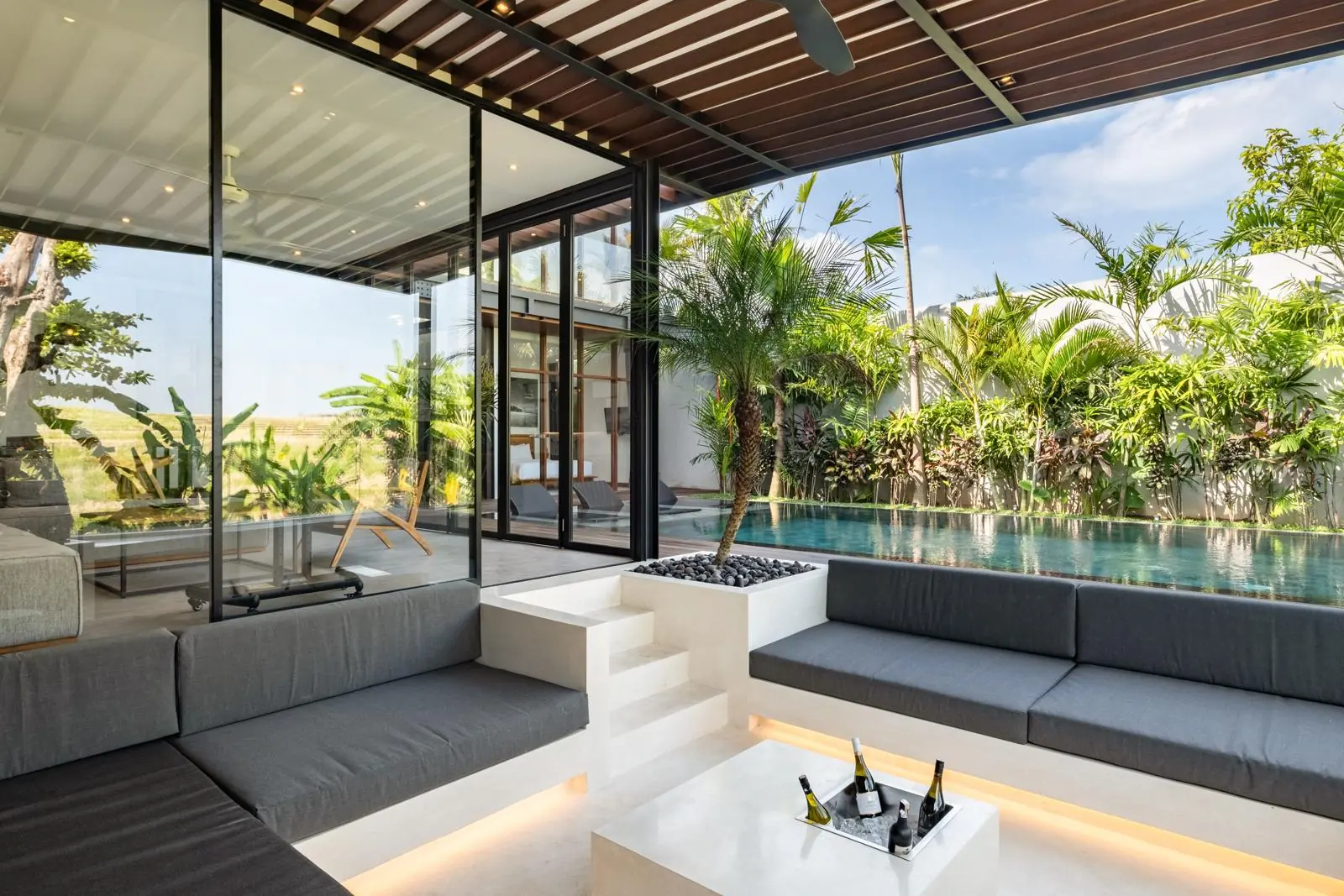 Sunken outdoor lounge beside the pool with rice field views River Paradise 4BR Pererenan Bali