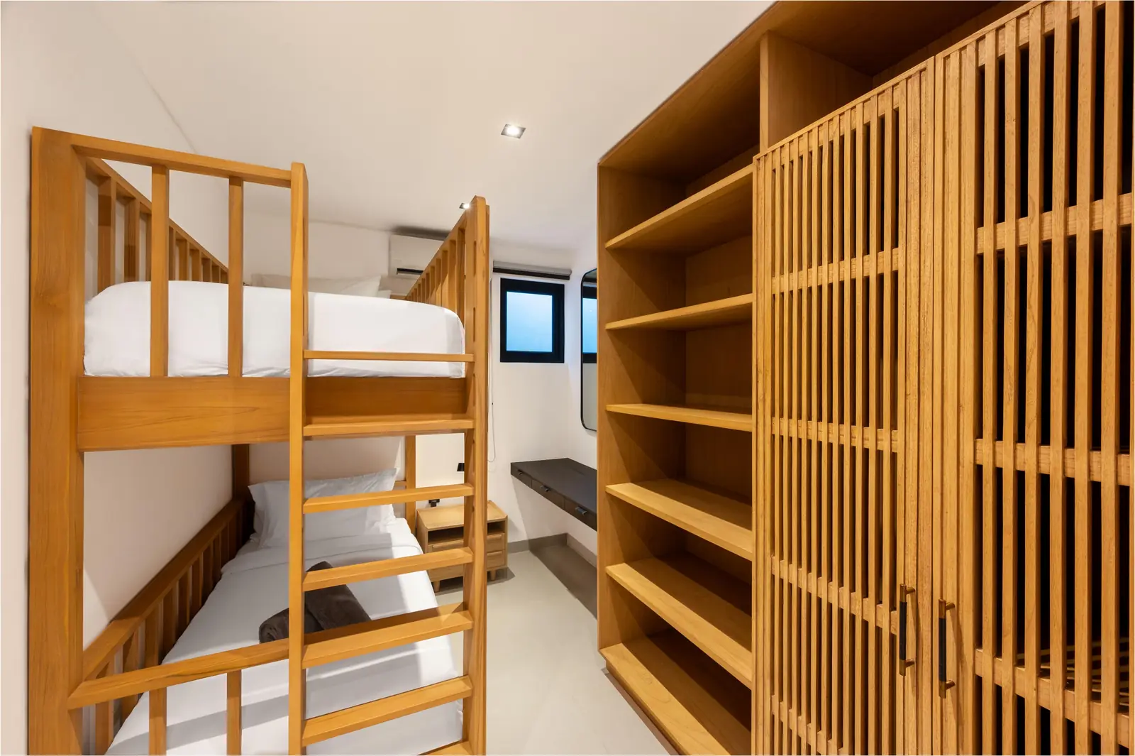 The Bunk Room with a teak bunk bed and slatted teak wardrobe MAR Bali 1 luxury villa Pererenan Bali