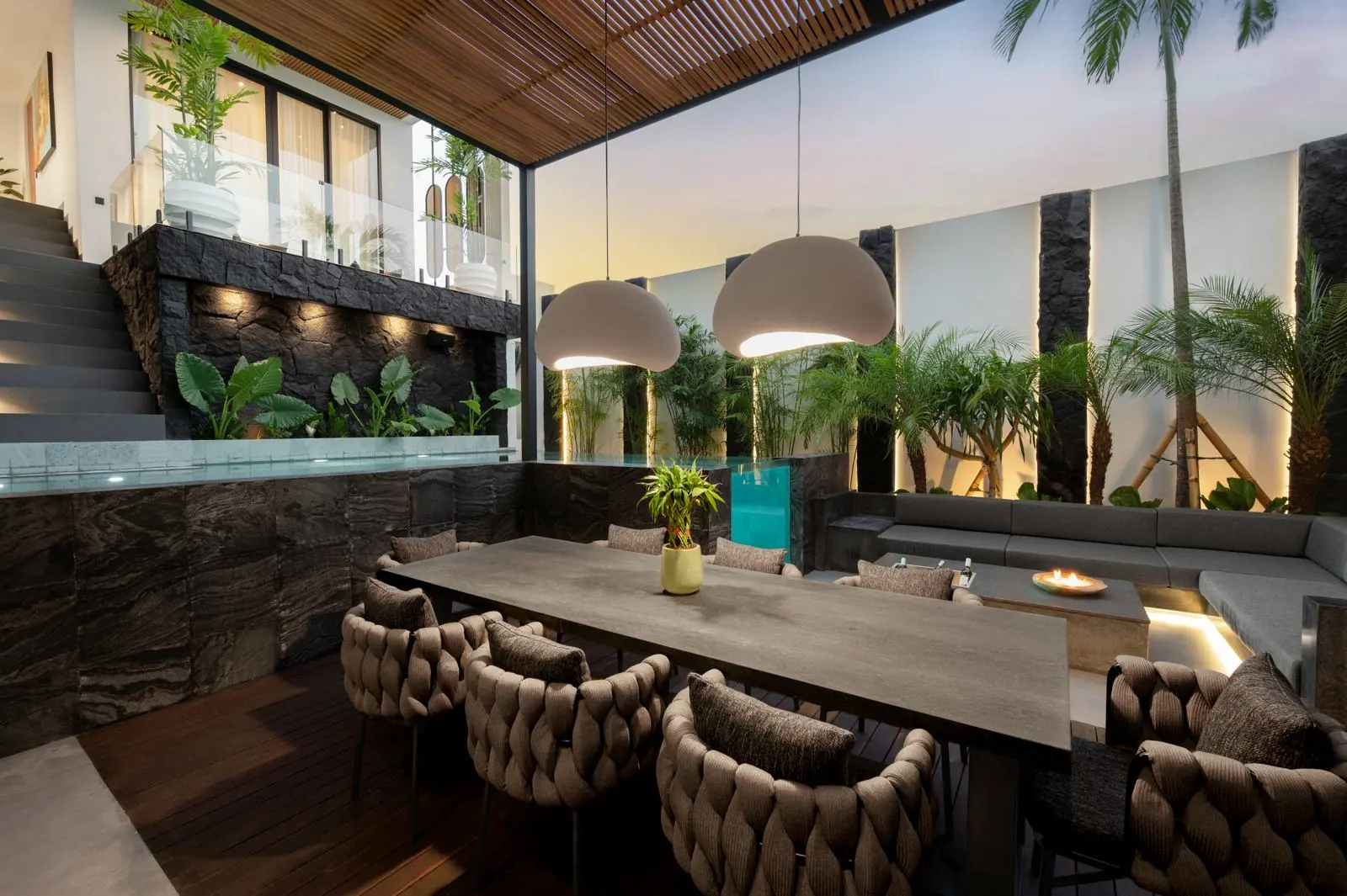 Outdoor dining table beside the glass-walled pool MAR Bali 1 Pererenan Bali